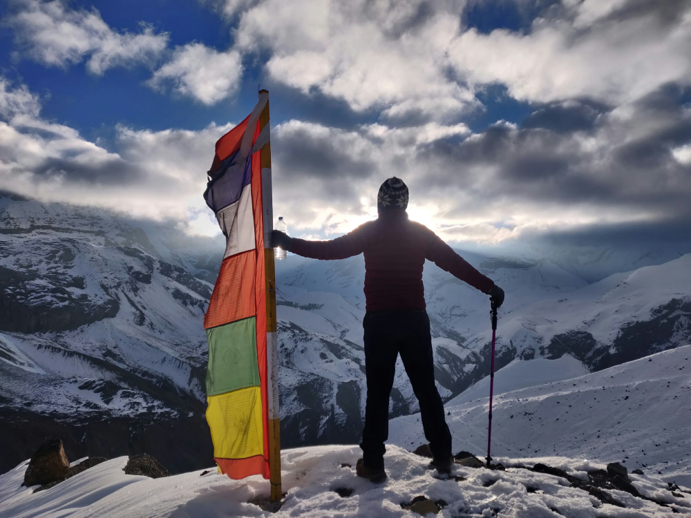 a-trekkers-celebrates-triumph-at-thorang-la-pass.png