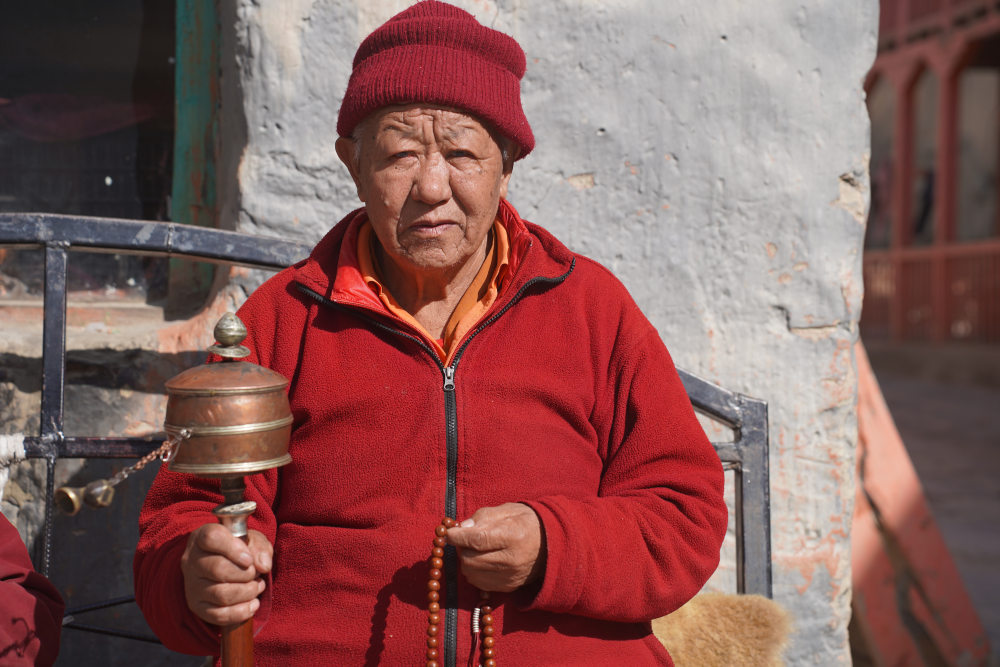 a-monk-in-chhoede-gompa-swings-his-prayer-wheel.png